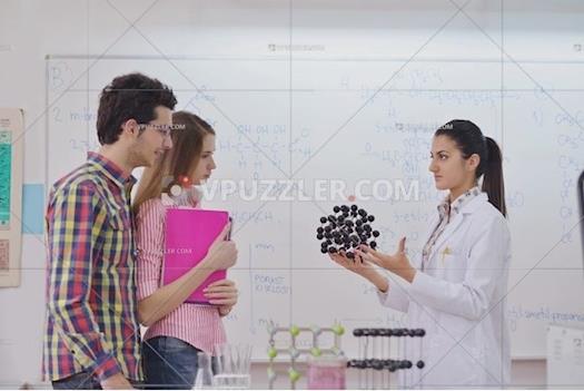 Stock Image - Students With a Model of Chemical Molecules