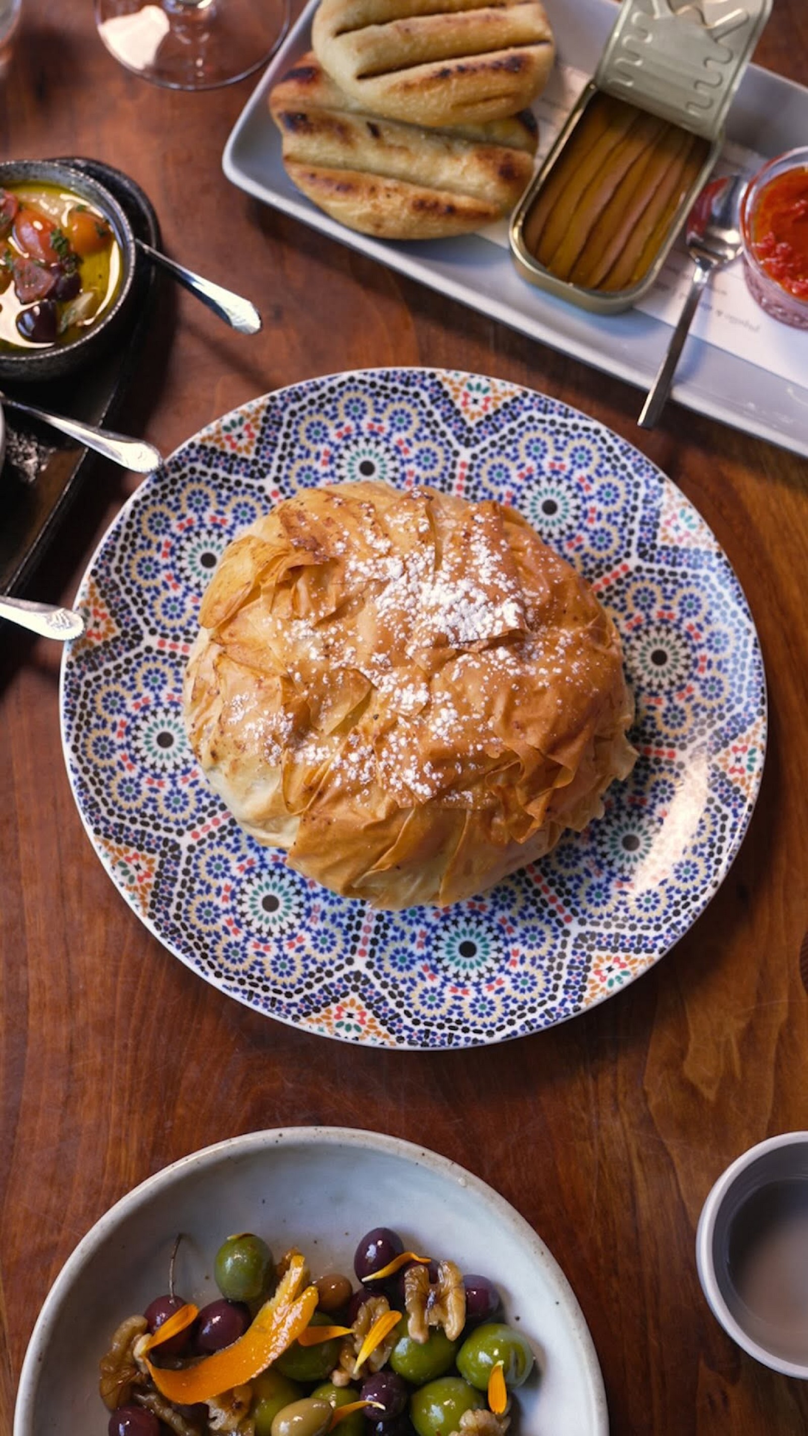 Some things in life are worth the wait — and the basteeya at Aziza in San Francisco is one of them. This flaky, golden m...