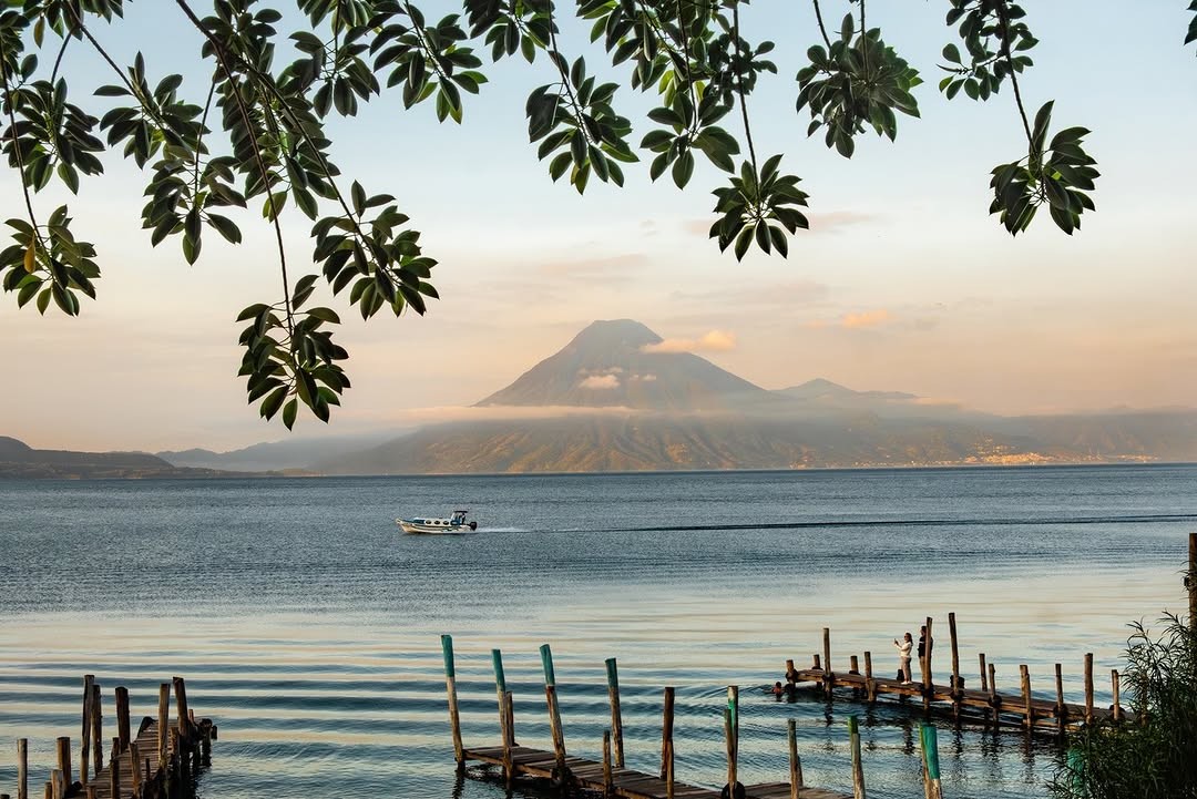 Photo by @francescolastrucci | Volcán San Pedro is seen from the shore of Lake Atitlán at sunrise. Surrounded by three m...